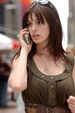 Image of Petra: a brunette, talking on the phone.